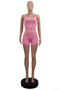 Full view of pink ribbed two-piece leisure set featuring tank top and matching shorts
