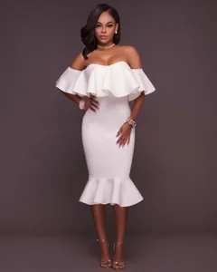 Elegant off-shoulder white dress featuring dramatic ruffles and a stylish mermaid hemline