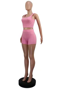 Pink ribbed two-piece leisure set featuring crop tank top and shorts shown on a mannequin