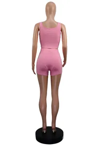 Detailed back view of pink ribbed two-piece sportswear set with crop top and mini shorts