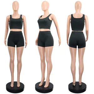 Three-view display of green two-piece athletic set with crop top and shorts