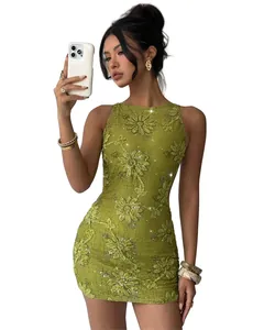 Close-up of green lace mini dress with delicate floral embroidery and shimmering sequins.