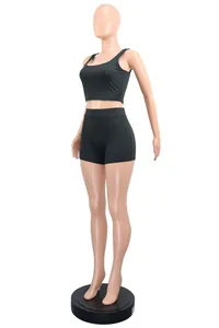 Full-body detail view of a black two-piece ribbed knit athletic set on a mannequin stand