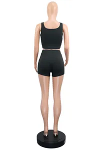 Back view of women's black ribbed two-piece sports set with crop tank and shorts