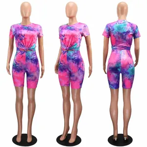 Front, side, and back view of vibrant pink and purple tie-dye two-piece set with biker shorts