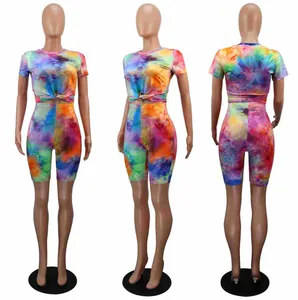 Front, side, and back views of vibrant tie-dye shorts and t-shirt two piece set