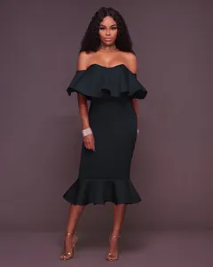 Elegant off-shoulder black dress with ruffled neckline and fishtail hem detail.