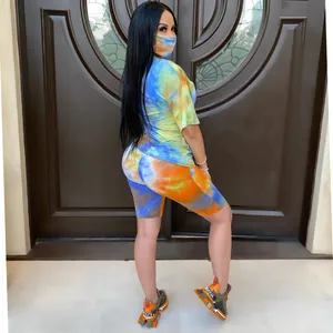 Vibrant tie-dye summer two-piece outfit featuring short sleeves and biker shorts