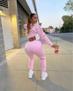 Trendy pink two-piece fleece tracksuit set with crop hoodie and matching joggers