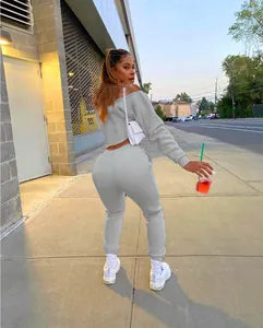 Full body rear view of gray two-piece off-shoulder tracksuit on model in street setting