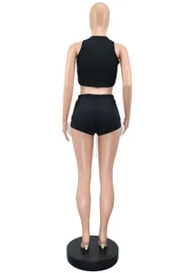 Rear view of black two-piece athletic set with sleeveless tank top and side slit shorts