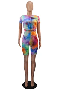 Vibrant tie-dye sports two-piece set with knotted crop top and high-waisted shorts.