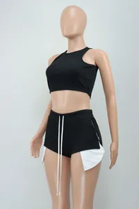 Side view detail of black sleeveless tank top and side slit shorts set on mannequin