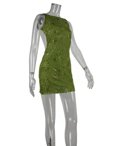 Detailed side view of sexy green lace embroidered mini dress with sequin detail and open back