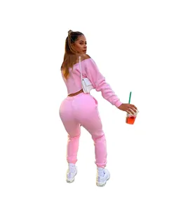 Back view of a woman wearing a pink off-the-shoulder two-piece fleece tracksuit set