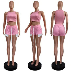 Three-way view of pink ribbed sleeveless crop top and matching drawstring shorts set