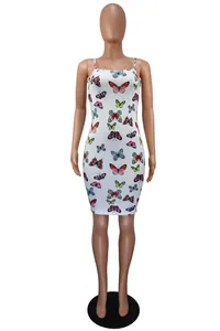 Detail of a white bodycon dress with colorful butterfly print and cami straps.