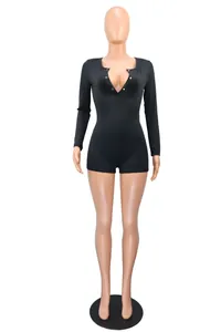 Front view of a sleek black long-sleeve V-neck romper featuring button details on a mannequin