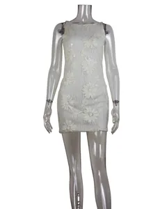 Detail view showing floral lace embroidery and sequins on a white mini party dress.