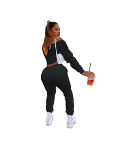 Back view of model wearing black off-shoulder sweatshirt and matching sweatpants set