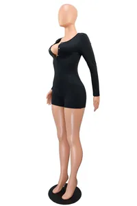 Close-up side view of sexy black long sleeve romper with deep V-neck button detail
