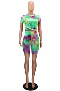 Detail view of vibrant tie-dye two-piece outfit with short sleeve top and biker shorts