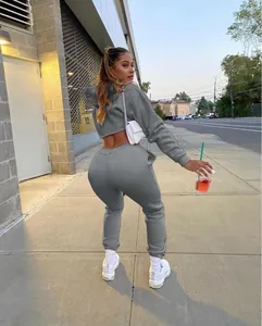 Women's casual grey two-piece fleece tracksuit showing back view on urban sidewalk
