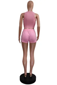 Back view of pink sleeveless ribbed crop top and matching mini shorts set on mannequin