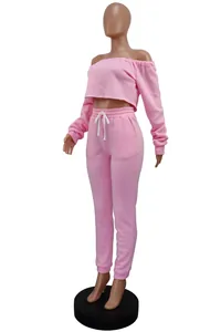 Detail view of pink off-the-shoulder crop top and matching sweatpants set on mannequin