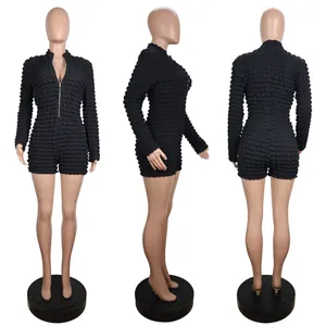 Detailed view showing the front side and back of a black bubble textured long sleeve romper