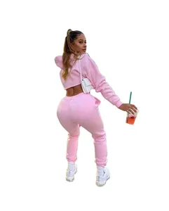 Detail showing the back view of a pink two-piece cropped fleece hoodie and sweatpants set