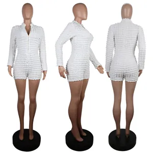 Detail view of white textured grid knit romper with front zipper in three angles