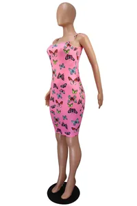 Three-quarter view of a pink camisole dress with vibrant butterfly prints on a mannequin