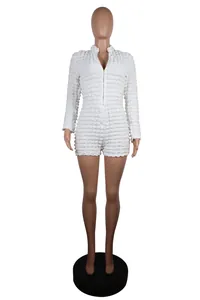 Front view of a white textured grid long-sleeve knit zip-up romper shown on a mannequin