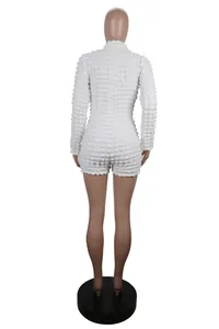 Back view of a white textured knit long-sleeve bodycon short jumpsuit on a mannequin