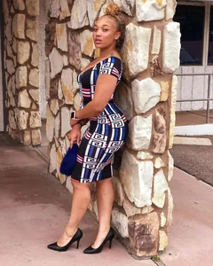 Detail view of off-shoulder digital print bodycon dress with vibrant geometric motifs.
