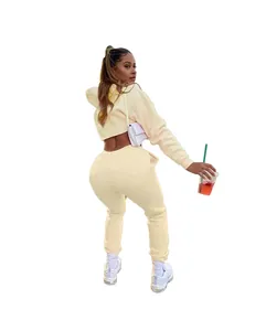 Rear view showing the fit of a soft cream solid cropped hoodie and sweatpants set
