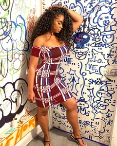 Detail view of off-the-shoulder bodycon dress featuring a bold geometric Greek key pattern