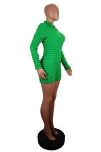 Detail of vibrant green long sleeve knit bubble texture romper with front zipper closure