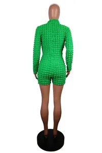 Detailed back view of a vibrant green textured popcorn knit long-sleeve jumpsuit