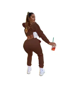 Detail view of women's two-piece brown tracksuit set with cropped hoodie and joggers
