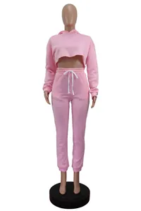 Front view of a pink two-piece tracksuit featuring a crop hoodie and drawstring joggers