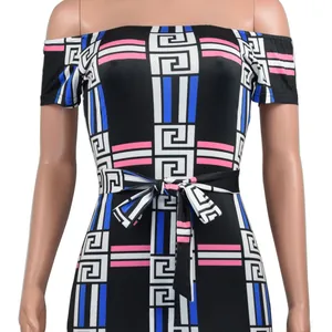 Close-up of off-shoulder dress featuring geometric digital print and waist tie.