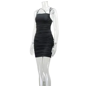 Close-up detail of a black ruched bodycon mini dress displayed on a clear mannequin
