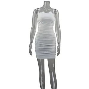 Detailed macro view of white ruched bodycon dress featuring elegant tie-back straps