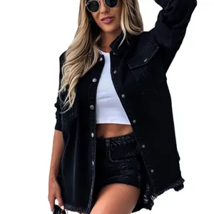 Detailed view of women's black distressed denim jacket with frayed hem and long sleeves