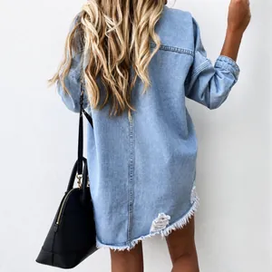 Back view of a light blue distressed mid-length denim jacket with ripped hem detail