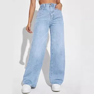 Model wearing stylish light blue high-waisted wide-leg denim jeans against white.