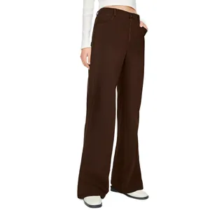 Detail shot showing the fit and chocolate brown fabric of high-waisted straight trousers