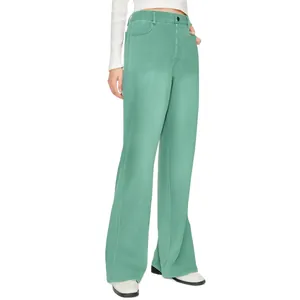 Detailed view of high-waisted green wide-leg trousers showing fabric texture and fit